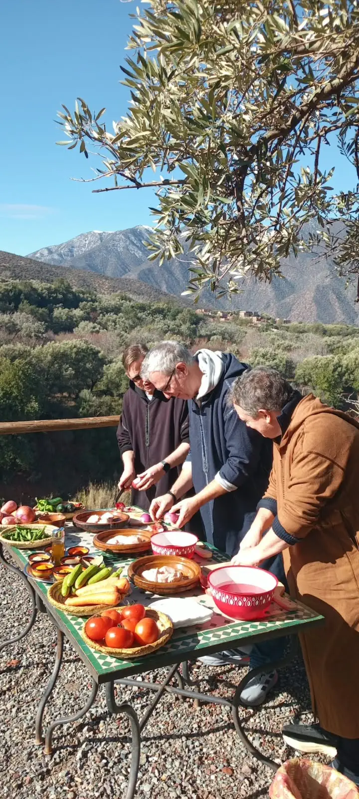 Participants préparant des légumes frais lors d'un atelier de cuisine en plein air